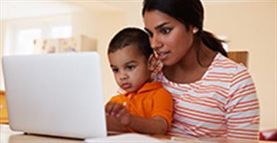 mother and sone look at laptop