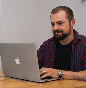 man uses online banking at home